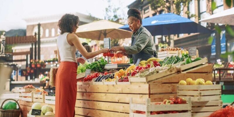 farmers-market-stall a female expat shopping for fresh vegetables at a local farmers market